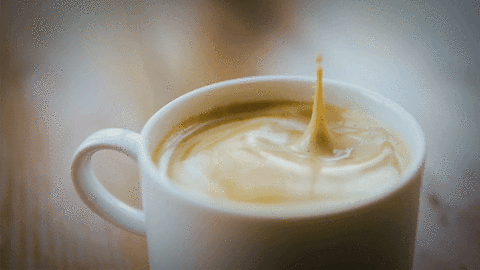 Foamy coffee being poured into a white mug for a morning energy boost