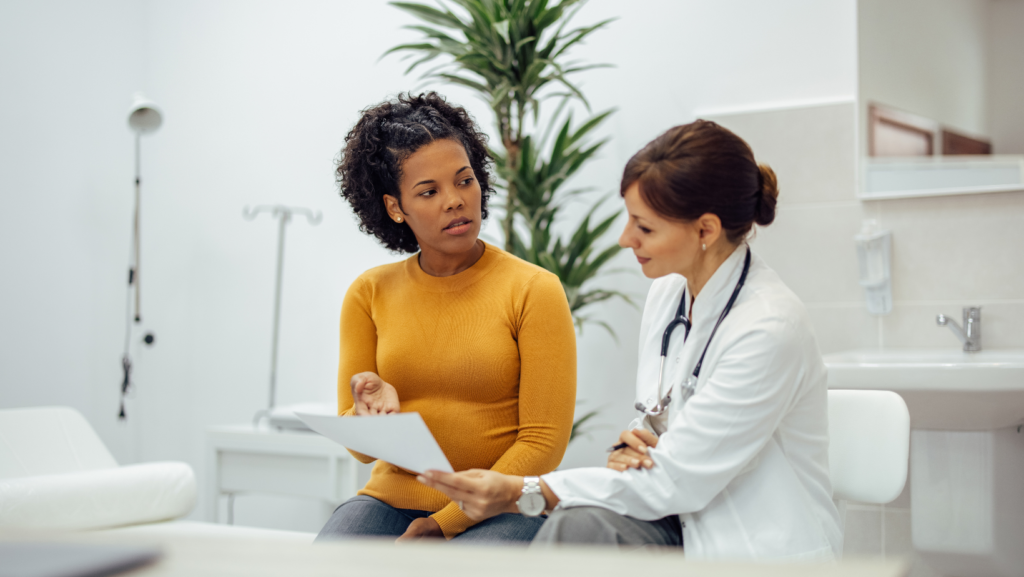 Black woman patient discussing care with her doctor during an appointment